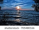 sun setting as viewed from association island henderson harbor new york