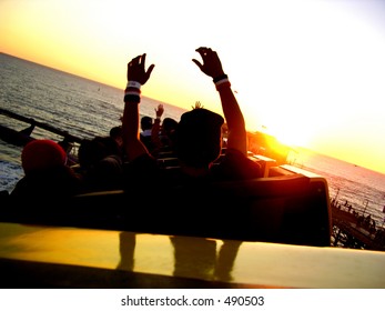 Sun setting while riding a roller coaster at the beach. - Shutterstock ID 490503