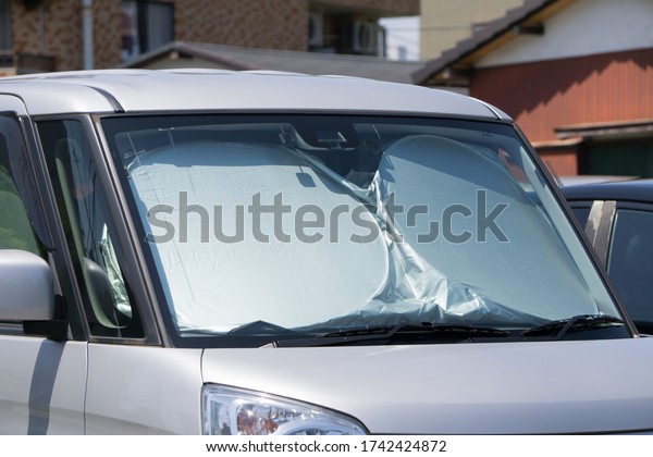 sun
shade or sun reflector on the windshield the
car