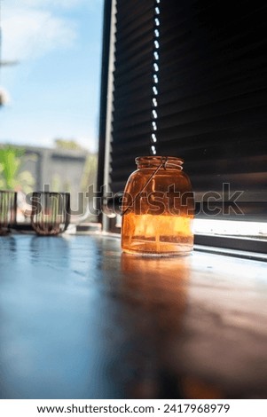 The sun shines in the background against the bright orange glass