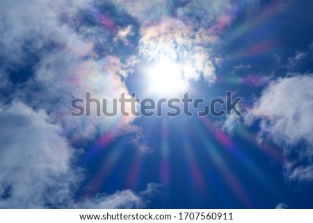 The sun shines in the clouds, refraction of rays, blurred background