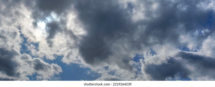 Sun shines through clouds on overcast sky - bright disc visible