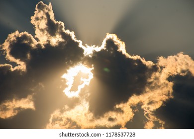 The Sun Shines Through The Clouds. (Sillhouette)