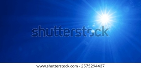 The sun shining in the blue sky