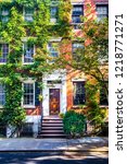 Sun shining down on a beautiful street with brownstones in West Village, New York 