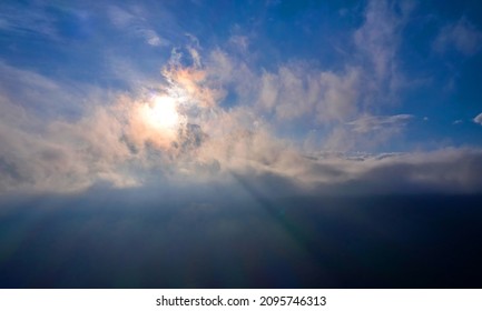 sun is shining in the mountains because of the clouds