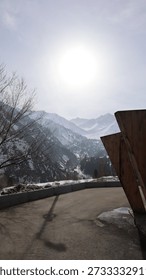 the sun is shining over the mountain range