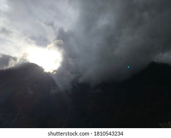 A sun shining through clouds 