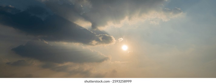 The sun shining through clouds