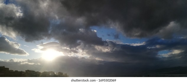 sun shining through the clouds in the cloudy sky