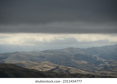 sun shining through the clouds down on the countryside