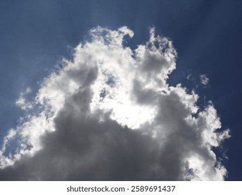 Sun shining through the clouds, high in the sky.