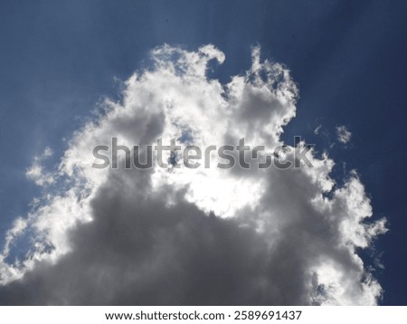 Sun shining through the clouds, high in the sky.