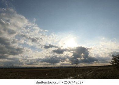Sun shining through clouds on beautiful sky