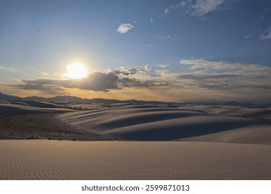 Sun Shining Through Clouds Over Rolling White Sand Dunes