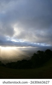 sun shining through the clouds over Pleasanton valley with wildflowers at springtime