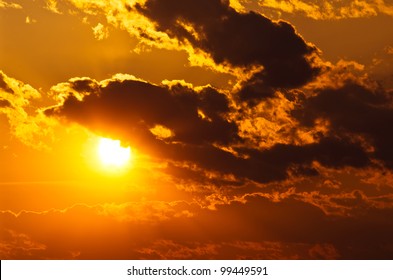 Sun Shining Through Clouds At Sunset