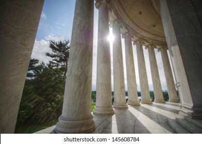 Sun shining through columns at the Jefferson Memorial in Washington DC