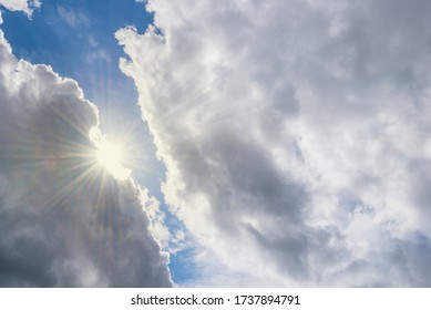 Sun Shining Through Cumulus Clouds