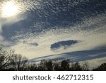 Sun shining through delicate clouds; Midwest, Missouri