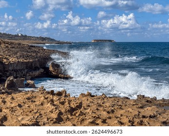 Sun shining through dramatic clouds over coastal landscape. Scenic view with sea horizon and sky reflections.