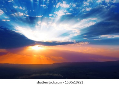 Sun shining through the low clouds of twilight