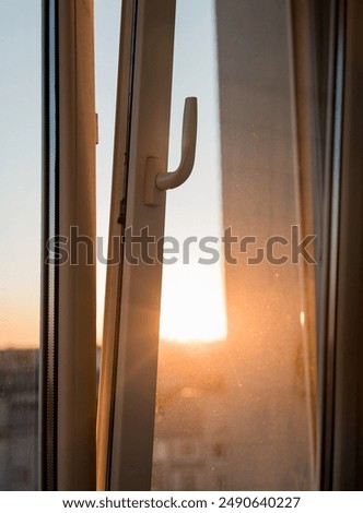 sun shining  through the open window on the balcony