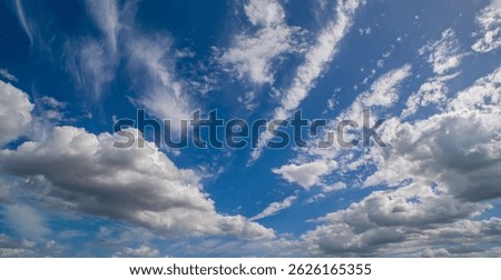 Sun shining through the puffy clouds. Sky view. Beautiful sunny sky. Background with clouds on blue sky. Clouds on blue sky.