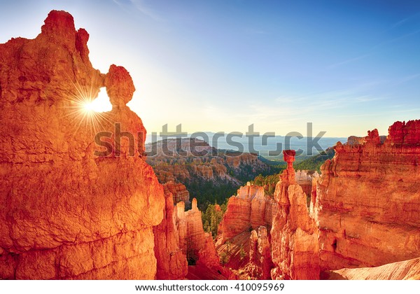 Sun is shining through\
the rock window in the early morning. Bryce Canyon National Park,\
Utah, USA. 