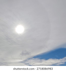 Sun Shining Through Thin Clouds in Blue Sky