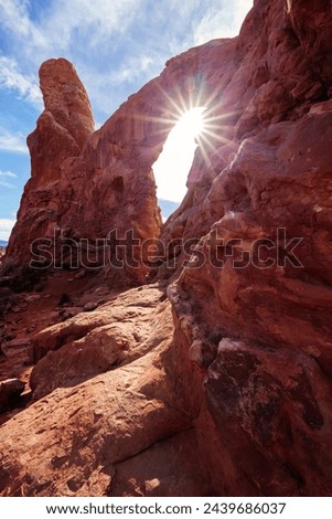 Sun shining through Turret Arch at Arches National Park in Moab, Utah