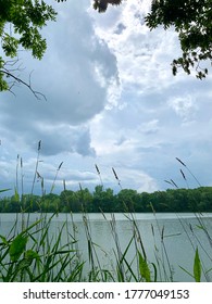 sun shining through while raining on lake