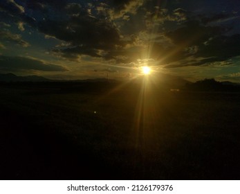 Sun shining thru grey clouds
