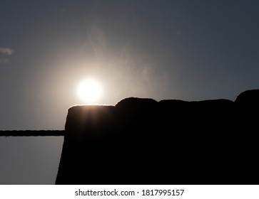 the sun with a silhouette of an object