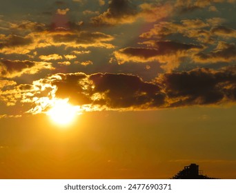Sun sinking below clouds over Lake Erie