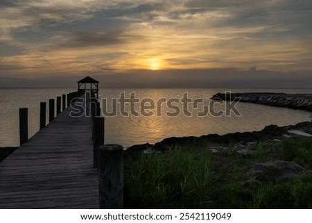 The sun sinks behind a cloud on the sound side of Salvo, North Carolina in the Cape Hatteras National Seashore. 