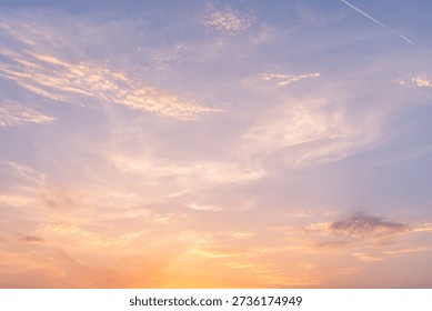 The sun sinks lower, brushing the edge of the world, and the sky unfolds like a slow-burning canvas. Clouds gather in layered bands, their once-muted grays awakened by streaks of molten gold. Light spills across them in sweeping gestures, tracing their curves with fire and honeyed amber.
Near the horizon, the colors deepen and bloom—apricot melting into coral, coral dissolving into rose. Some clouds seem to smolder from within, their undersides flushed with crimson and wine, while their upper edges glow softly, kissed by the last rays of day.
Above, the blue cools into indigo, creating a gentle contrast with the warmth below. Wisps of vapor drift like brushstrokes across the fading light, delicate and almost translucent. The sky feels vast yet intimate, as though it were quietly performing a farewell meant only for those who pause to look.
When the sun finally slips away, the brilliance softens rather than vanishes. The colors blur and breathe into one another—gold into pink, pink into violet—until the whole horizon hums with a subdued radiance. Night approaches not as an interruption, but as a tender continuation of the glow.