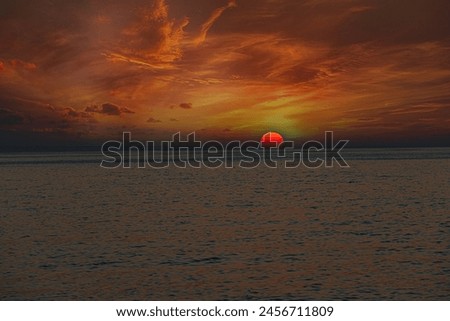 Sun sinks lower, casting long shadows across the waves, the world seems to slow down, enveloped in a peaceful stillness. 