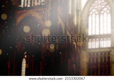 Sun spells by window with bright of light and particles indoors in church.