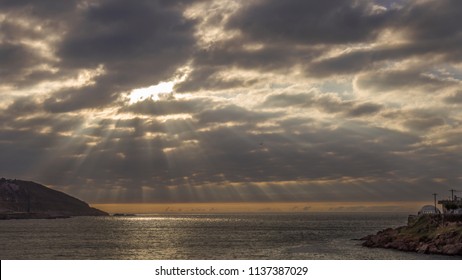 Sun through the clouds on the beach