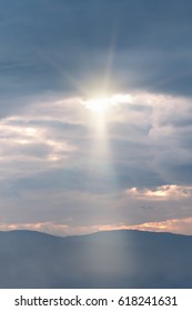 Sun through the clouds on a cloudy day in the mountains