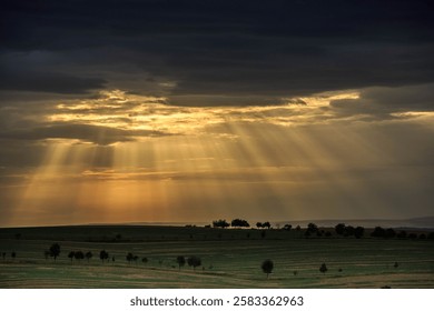 Sun traces rays sunset dark clouds