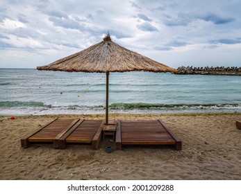 Sun umbrellas on the beach, sea water, golden sand