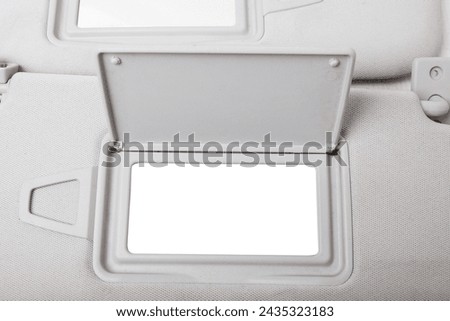 Sun visor with a mirror made of light gray plastic on a white background in a photo studio. Spare part of the car interior for replacement in a car service or for sale on auto dismantling.