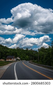 Sunapee Mountain Road and white cloudscape along Route 11 in Sunapee, New Hampshire, USA