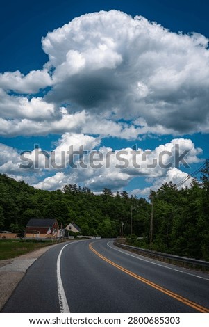 Sunapee Mountain Road and white cloudscape along Route 11 in Sunapee, New Hampshire, USA