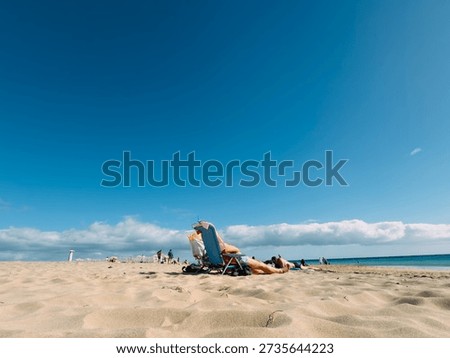 Sunbathing on the beach during summer vacation, relaxing holiday concept with warm sunlight, leisure time, travel freedom and seaside lifestyle atmosphere