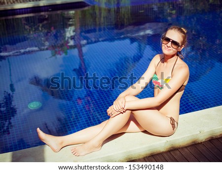 Similar – Brunette surfer woman with top and bikini holding surfboard