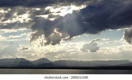 sunbeams between clouds over the sea