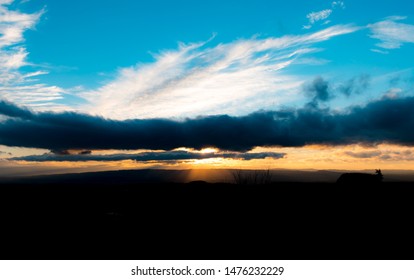 
sunbeams between clouds at sunset